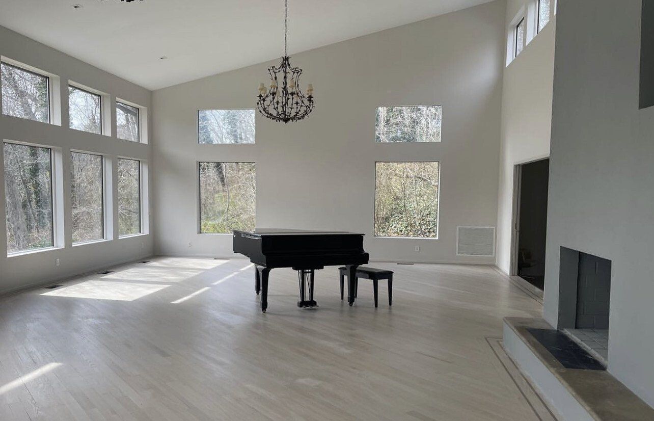 Large living room professionally painted with piano