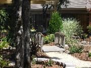 There is a small bridge in the middle of the garden.