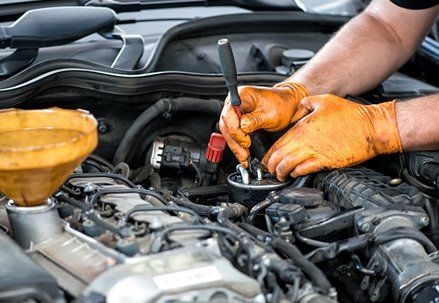 Transmission Shop — Car Mechanic Checking the Engine in Lockport, IL