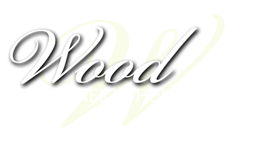 Stylized silver script reading &ldquo;Wood&rdquo; on a white background with a faint yellow shadow