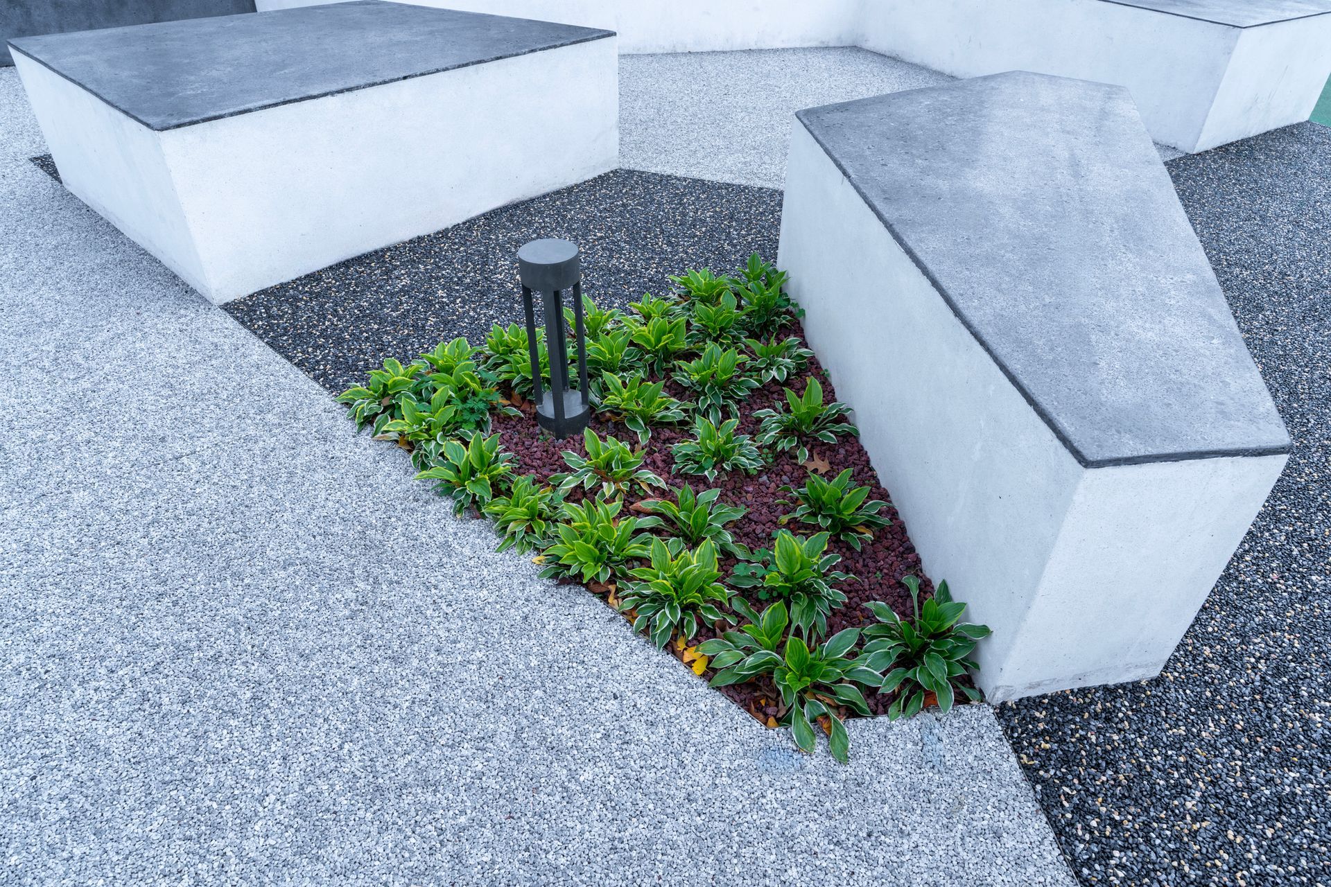 A fire pit is sitting in the middle of a lush green field.