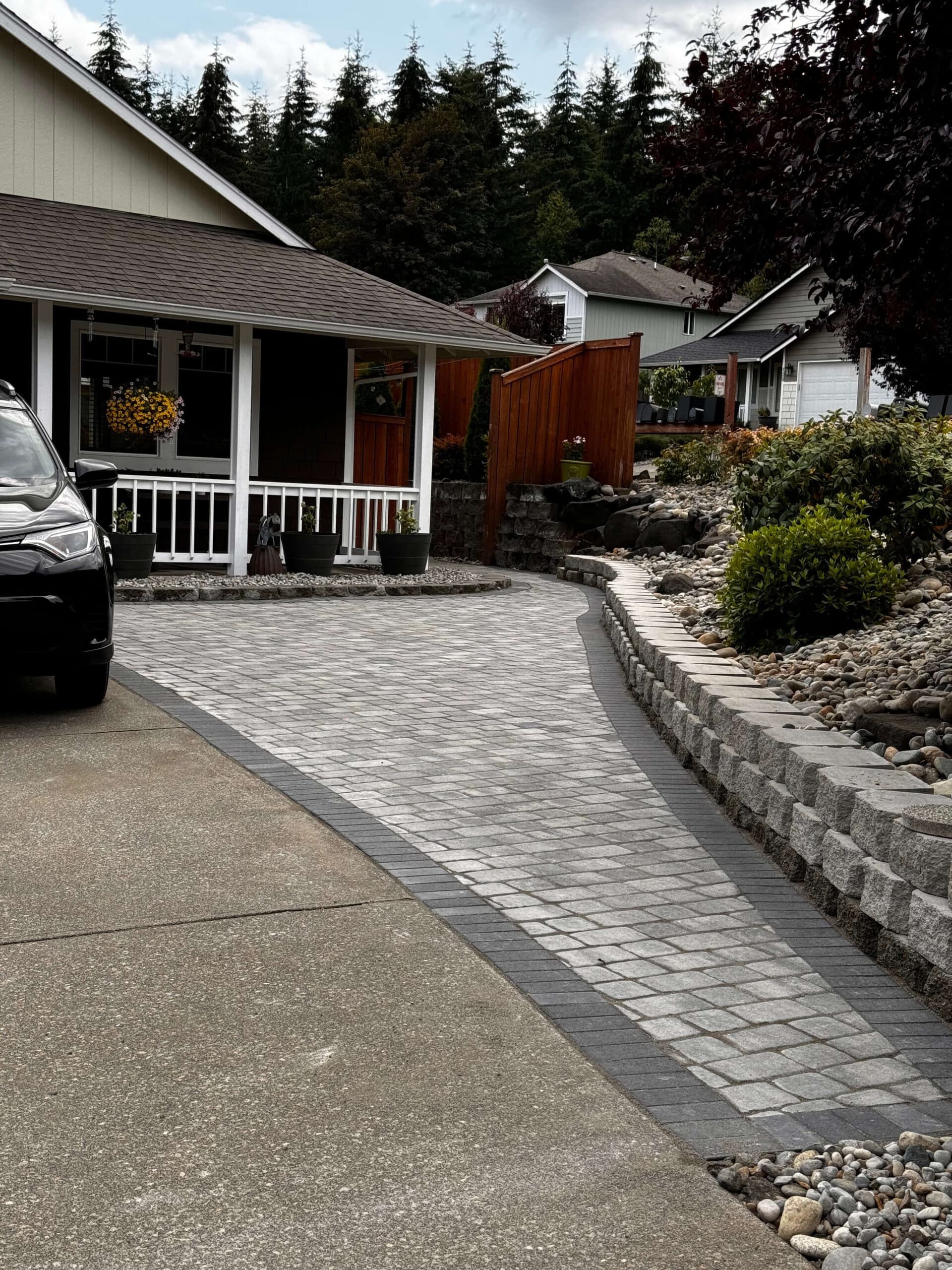 A car is parked in a driveway in front of a house