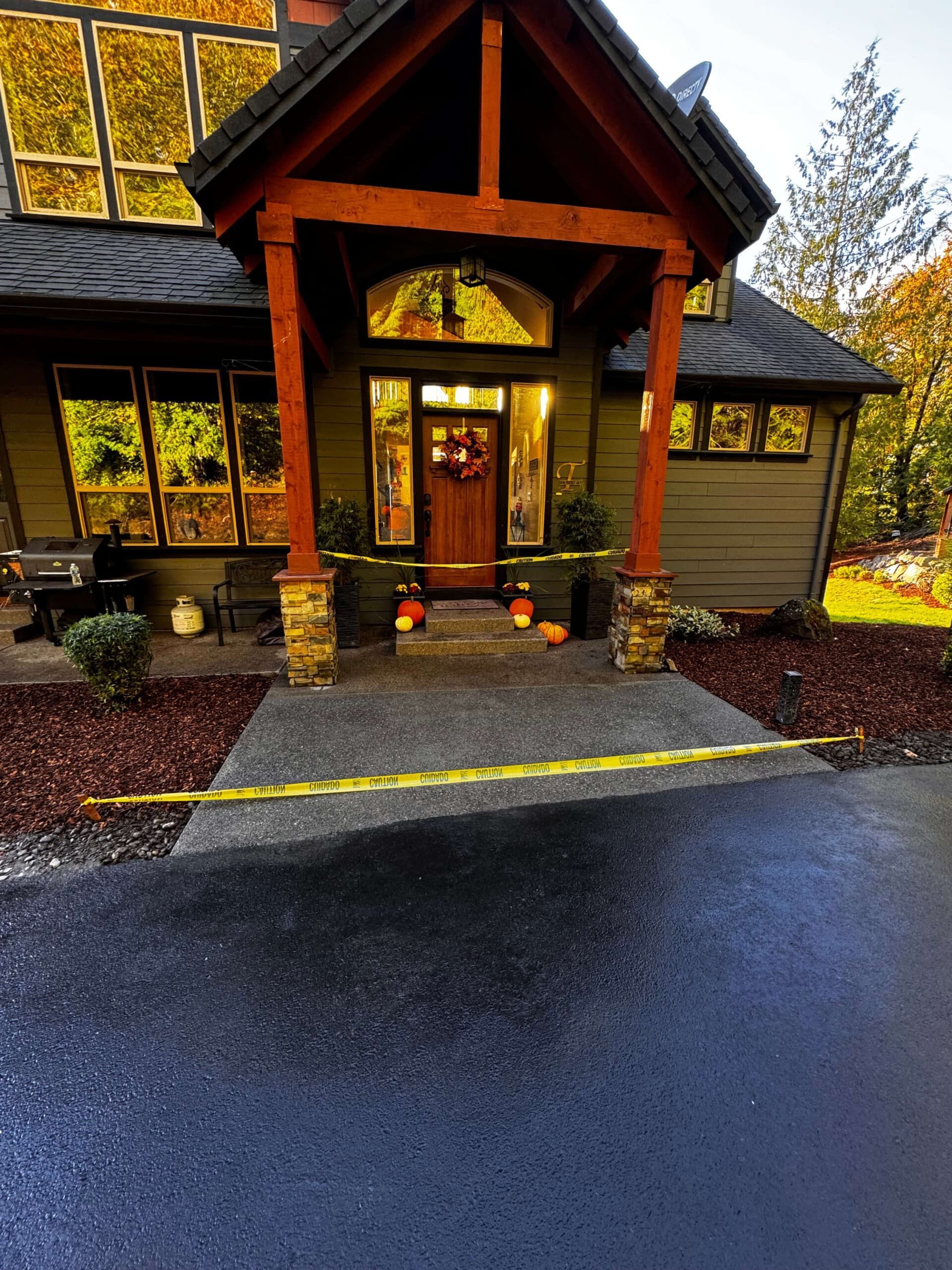 A backyard with a wooden fence and a table and chairs