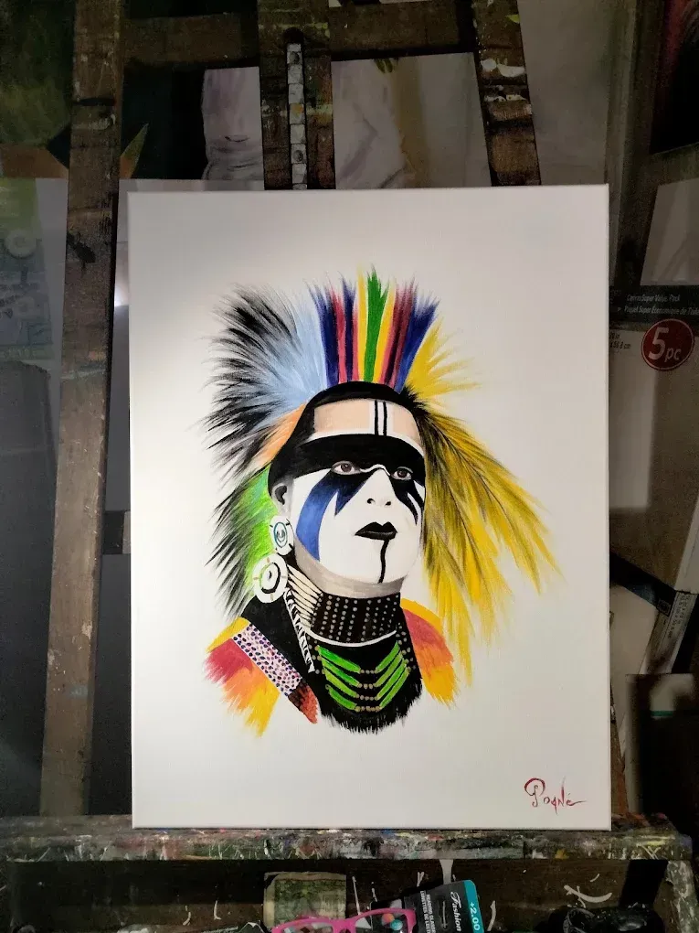 A painting of a native american with a mohawk is on an easel.