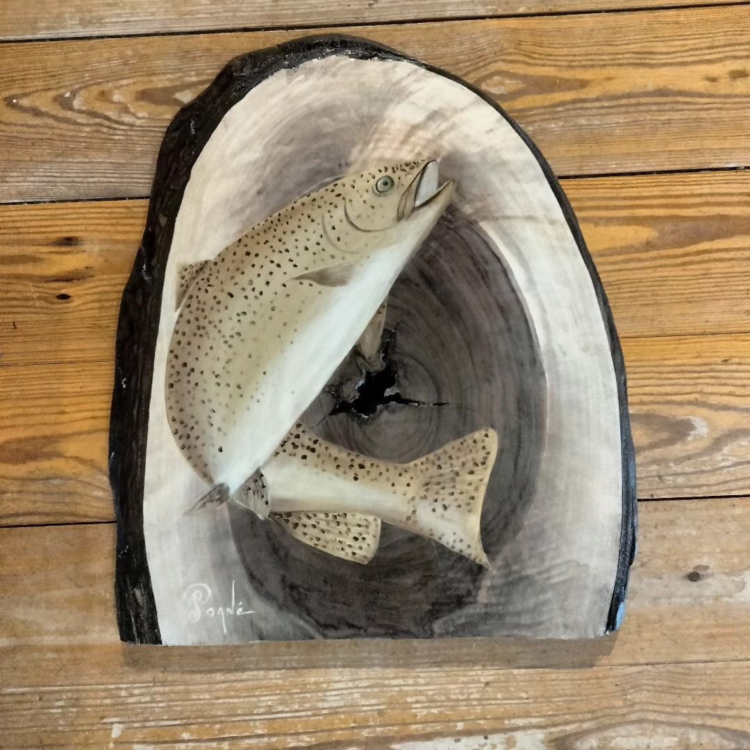 A painting of a fish on a piece of wood