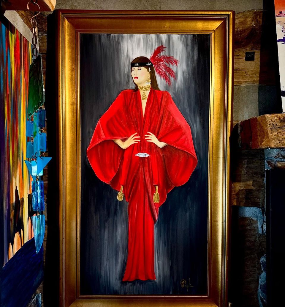 A framed painting of a woman in a red dress