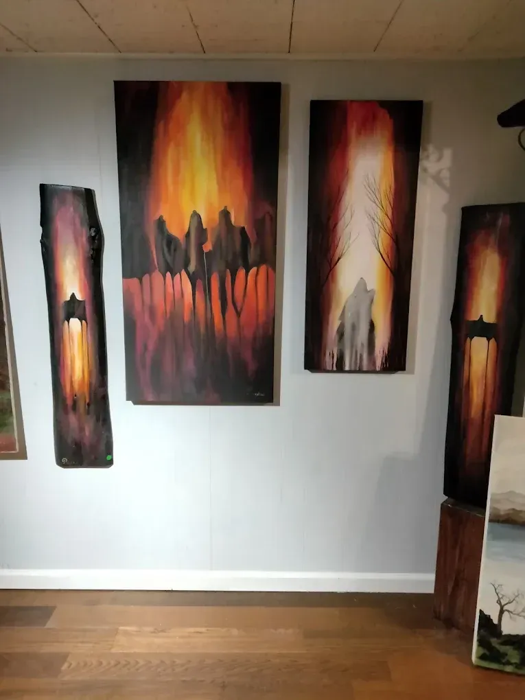 A room with a lot of paintings on the wall