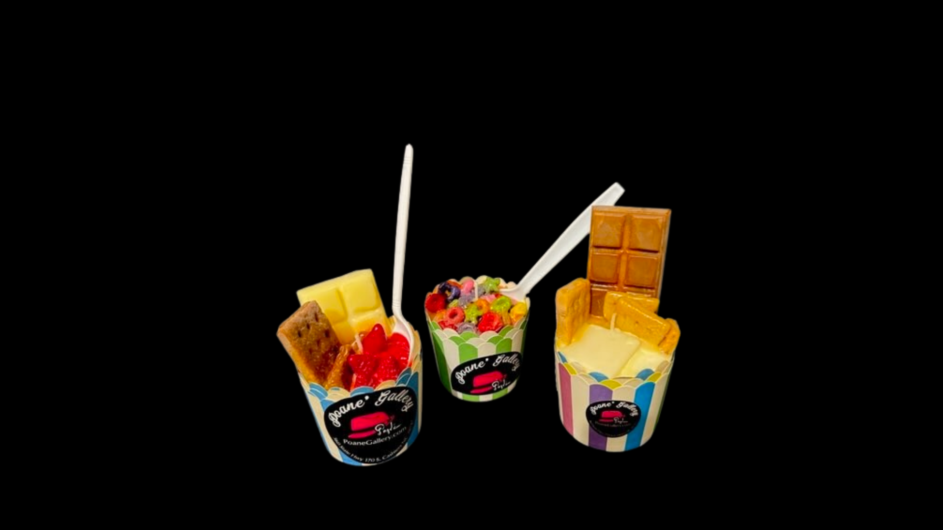 Three cups of ice cream with a spoon in them on a black background.