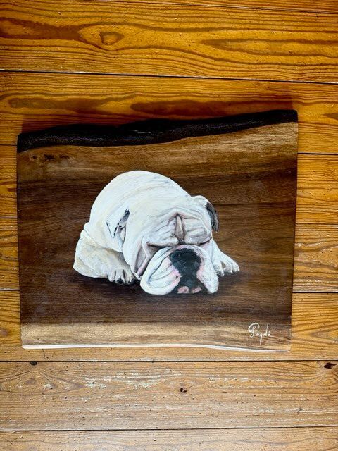 A painting of a bulldog sleeping on a wooden surface.