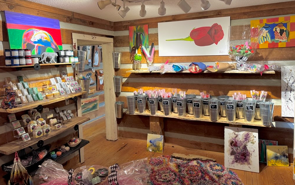 A room with a lot of shelves and paintings on the wall.