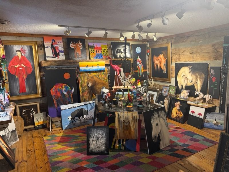 There are many paintings on the wall in this room.