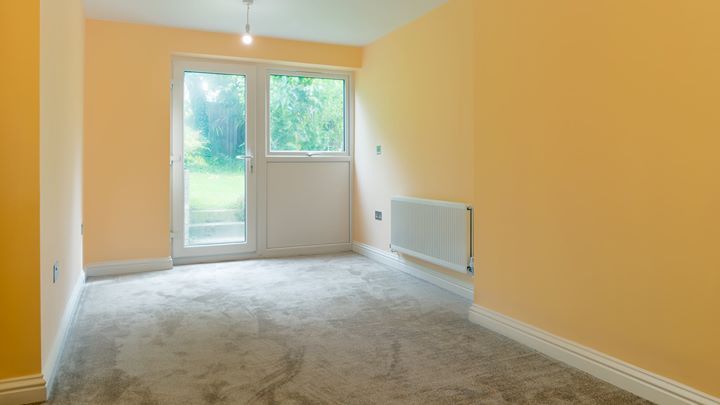 This a bedroom with door access to the garden 