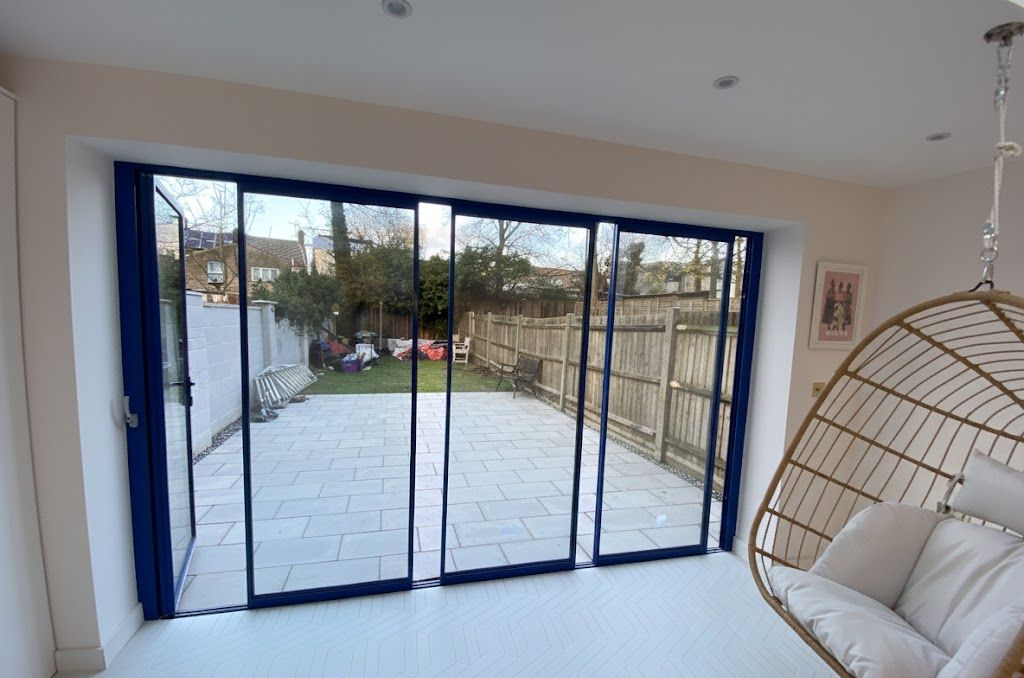 Interior view of slimline blue bifold doors for a London kitchen extension by Ibex Builders E17.
