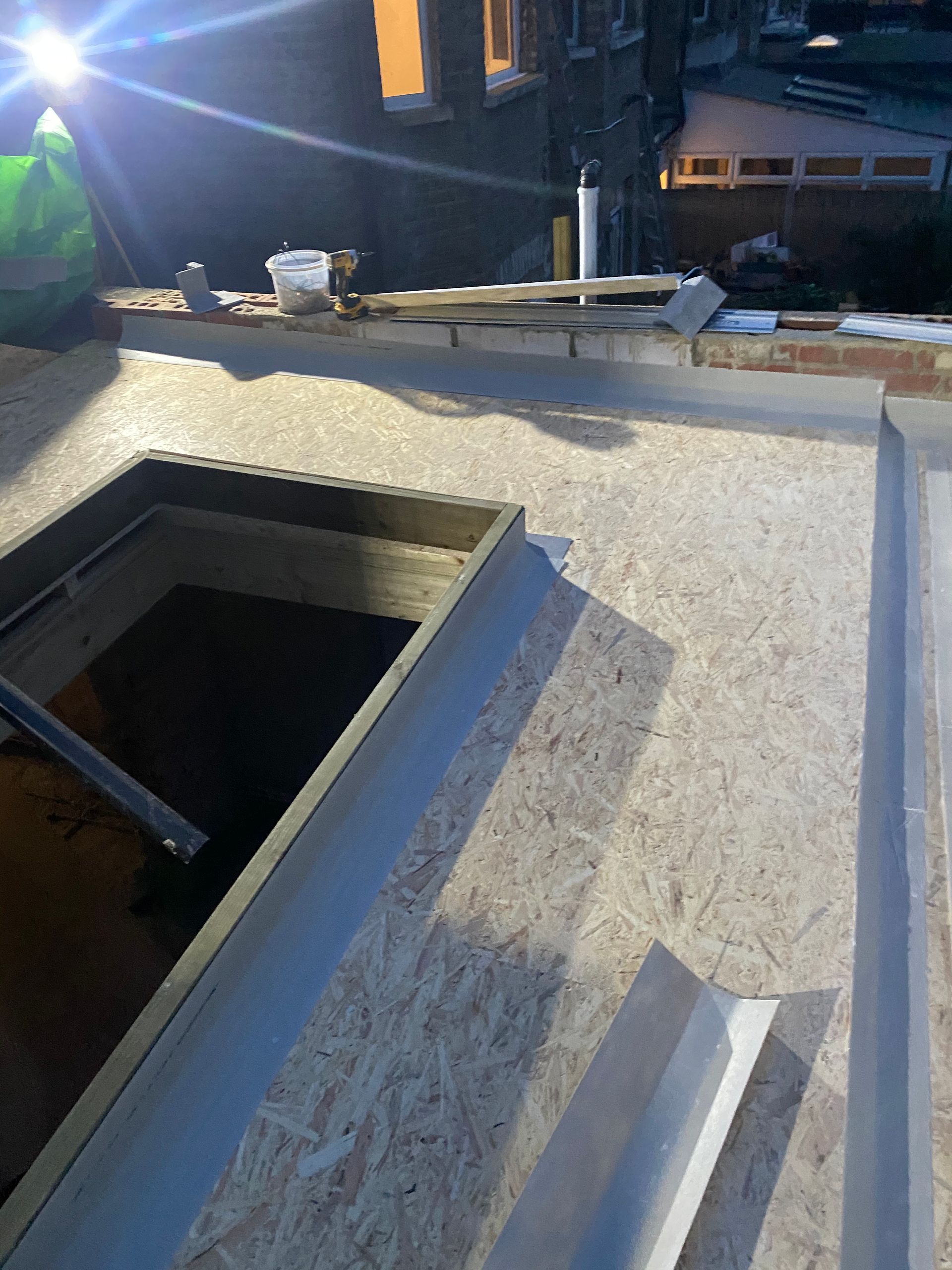 Ibex Builders finishing a flat roof installation with a custom roof lantern opening in Walthamstow E17.