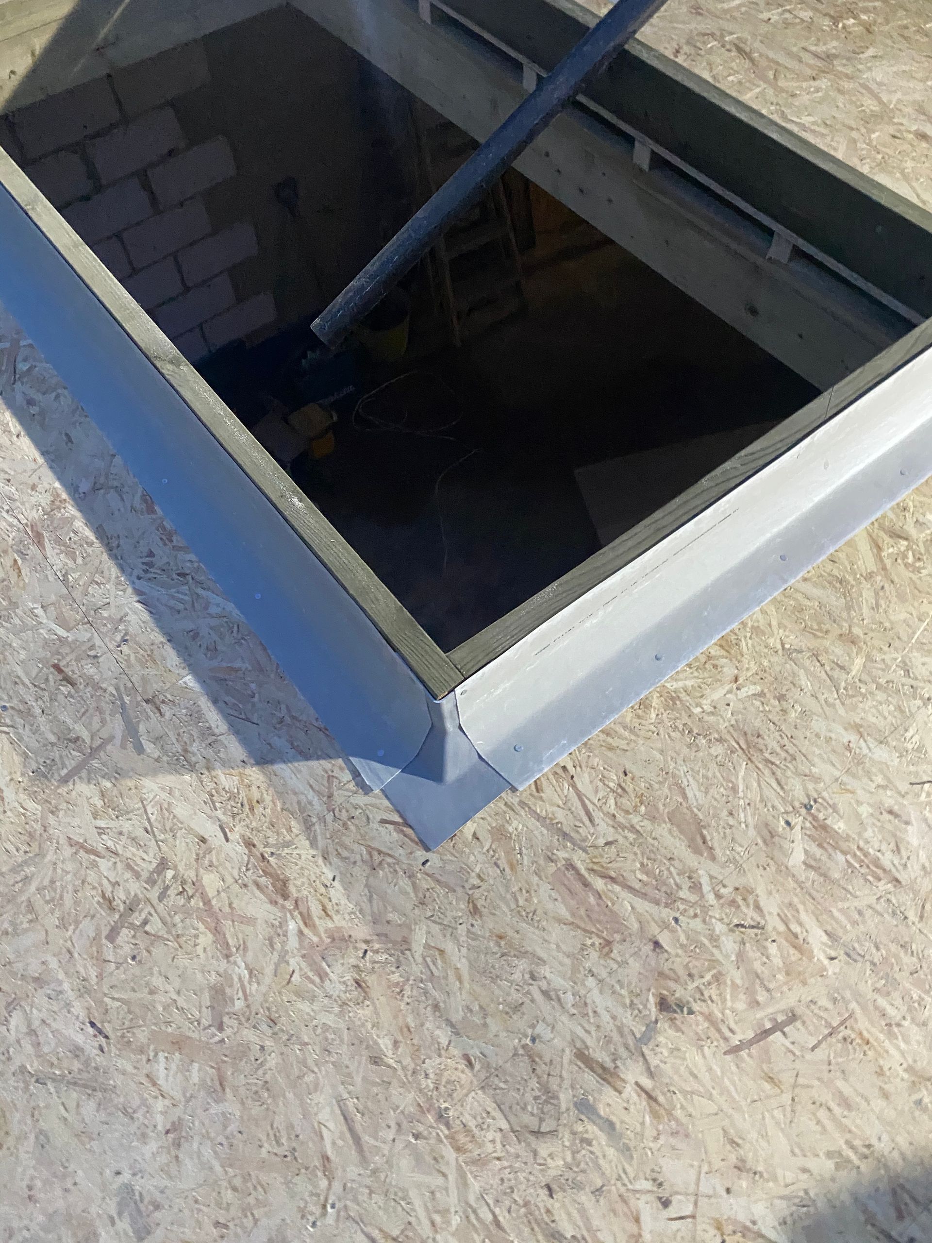 Close-up of roof lantern aperture and flat roof preparation by the Ibex Builders team.