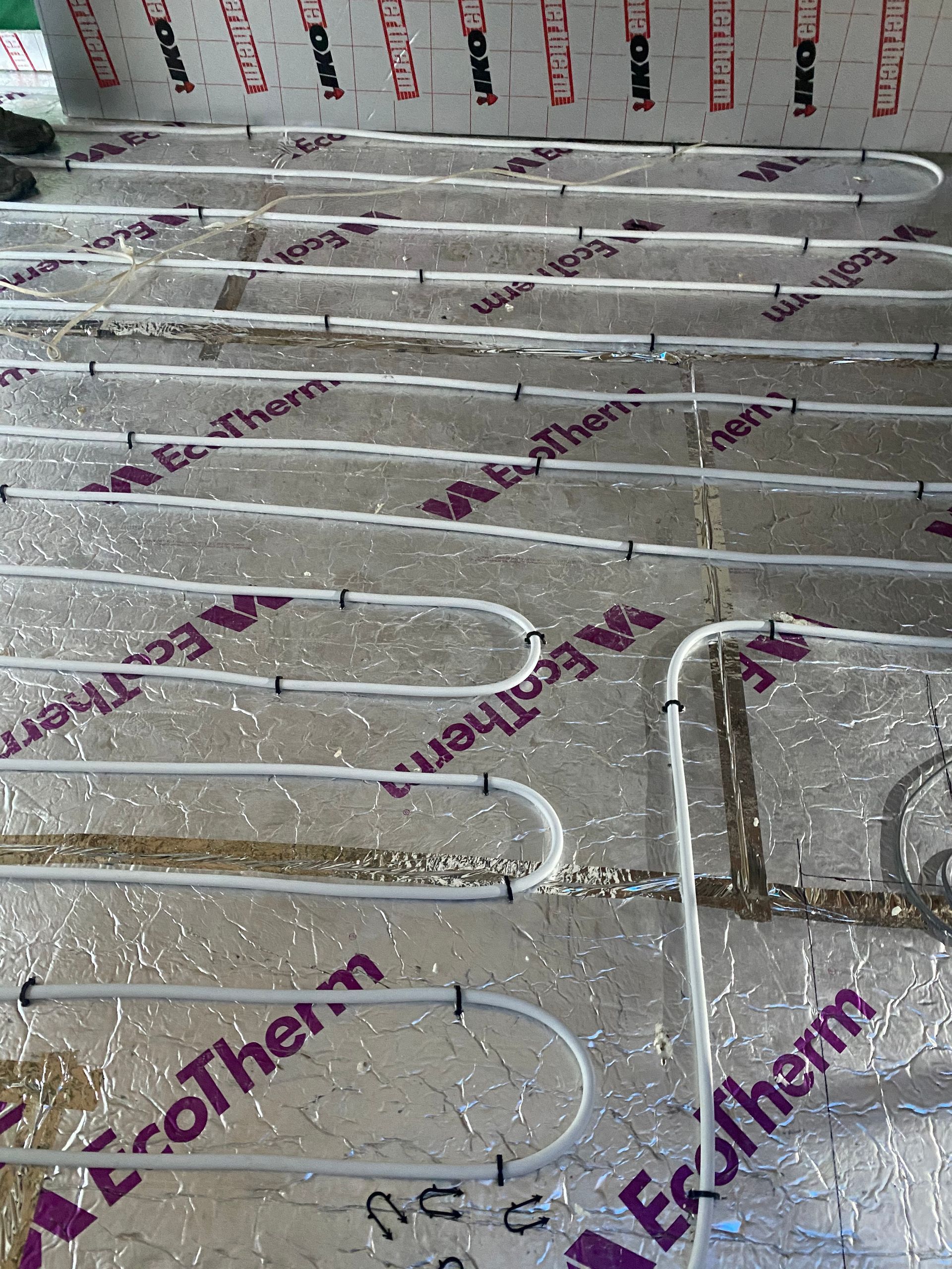 bex Builders installing underfloor heating pipes over insulation for an E17 kitchen extension.