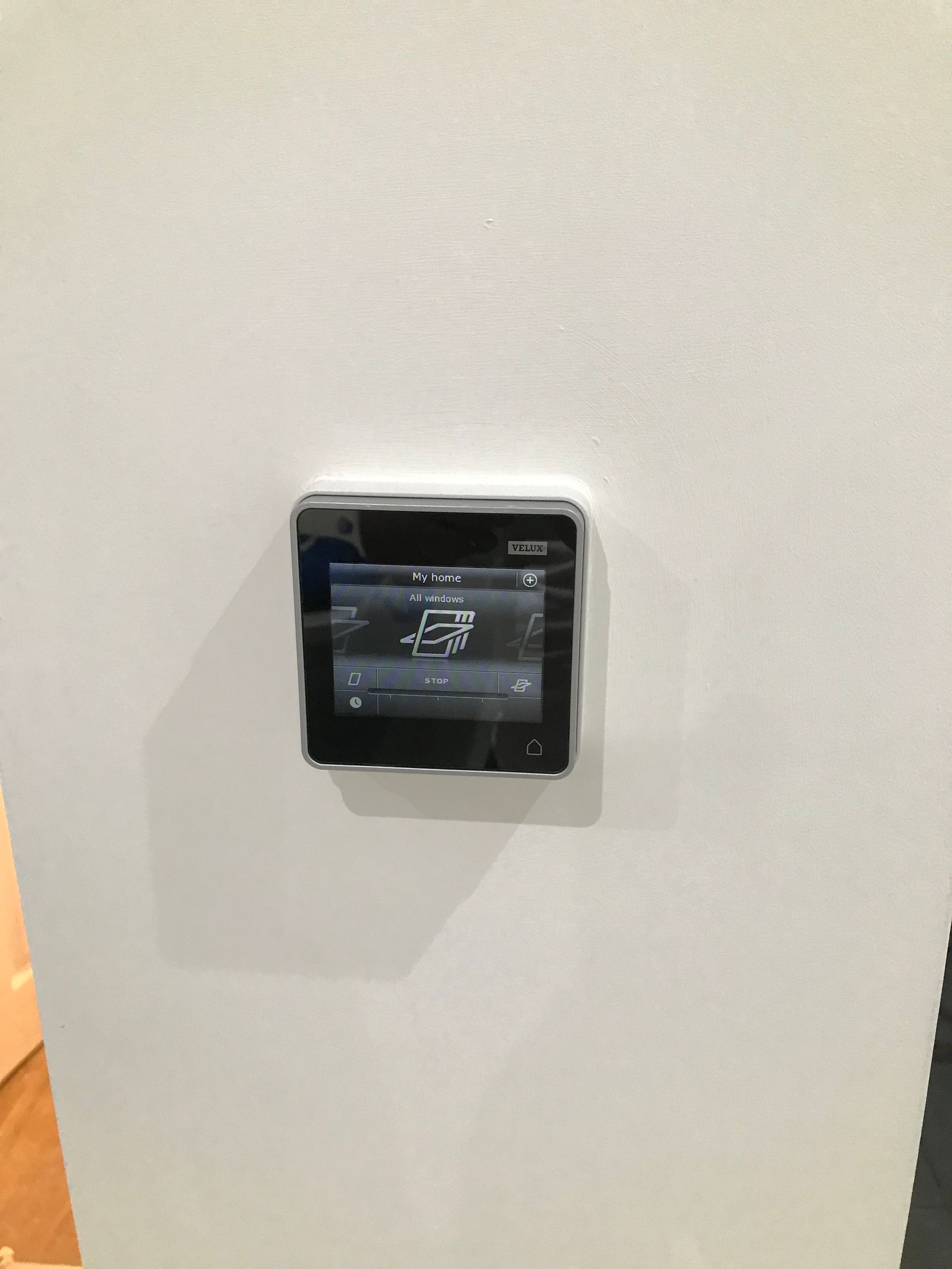 Wall-mounted control panel for automated electric rooflights in a Walthamstow loft conversion by Ibex Builders.