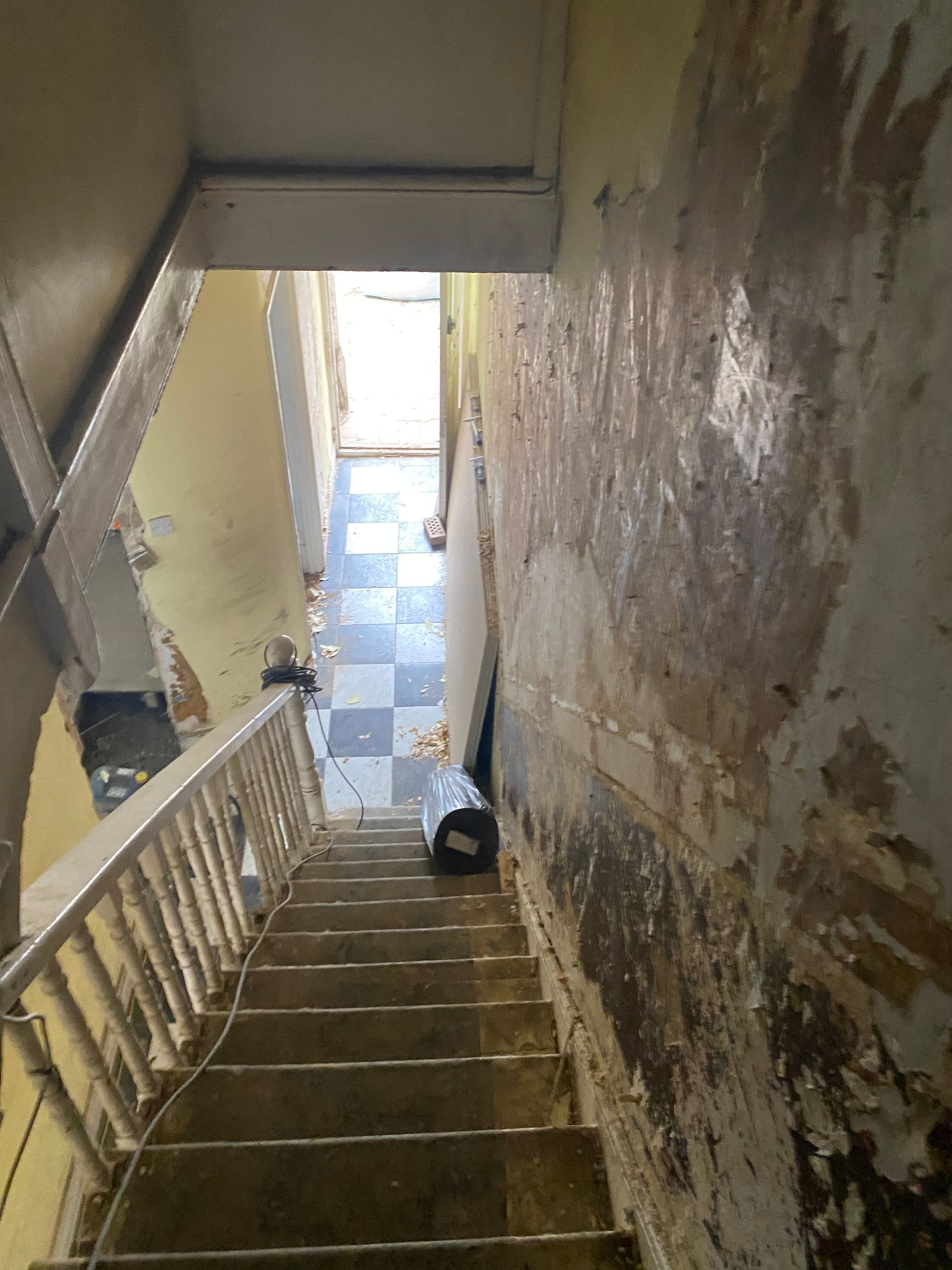 Ibex Builders hallway renovation in Leytonstone E11 showing stripped walls and period features.