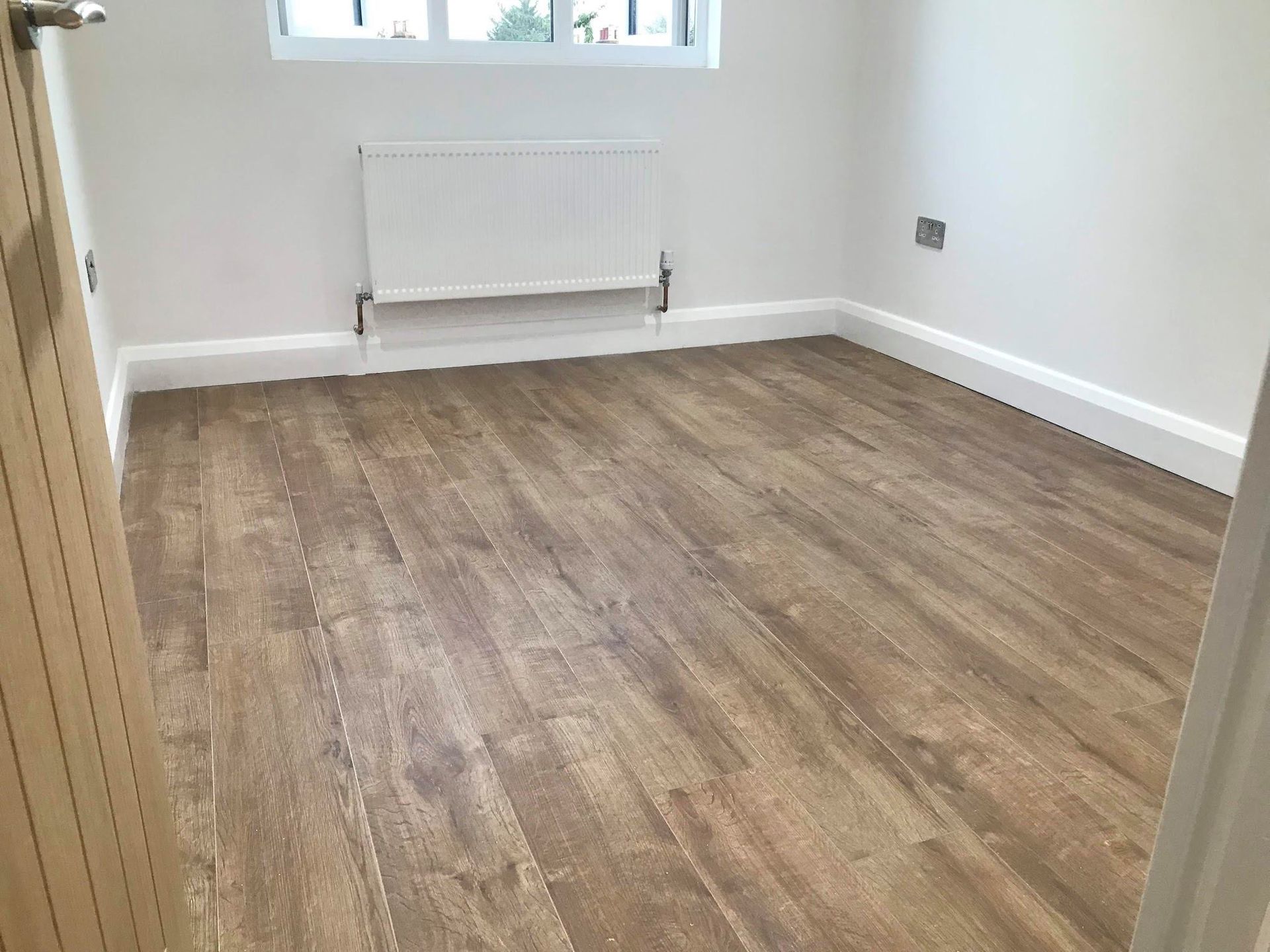 New laminate flooring installed in a Walthamstow E17 home renovation and loft by Ibex Builders.