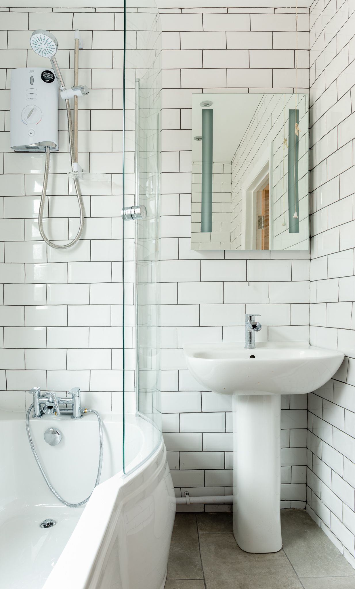 Luxury bathroom with LED mirror and walk-in shower in a Walthamstow home by Ibex Builders.