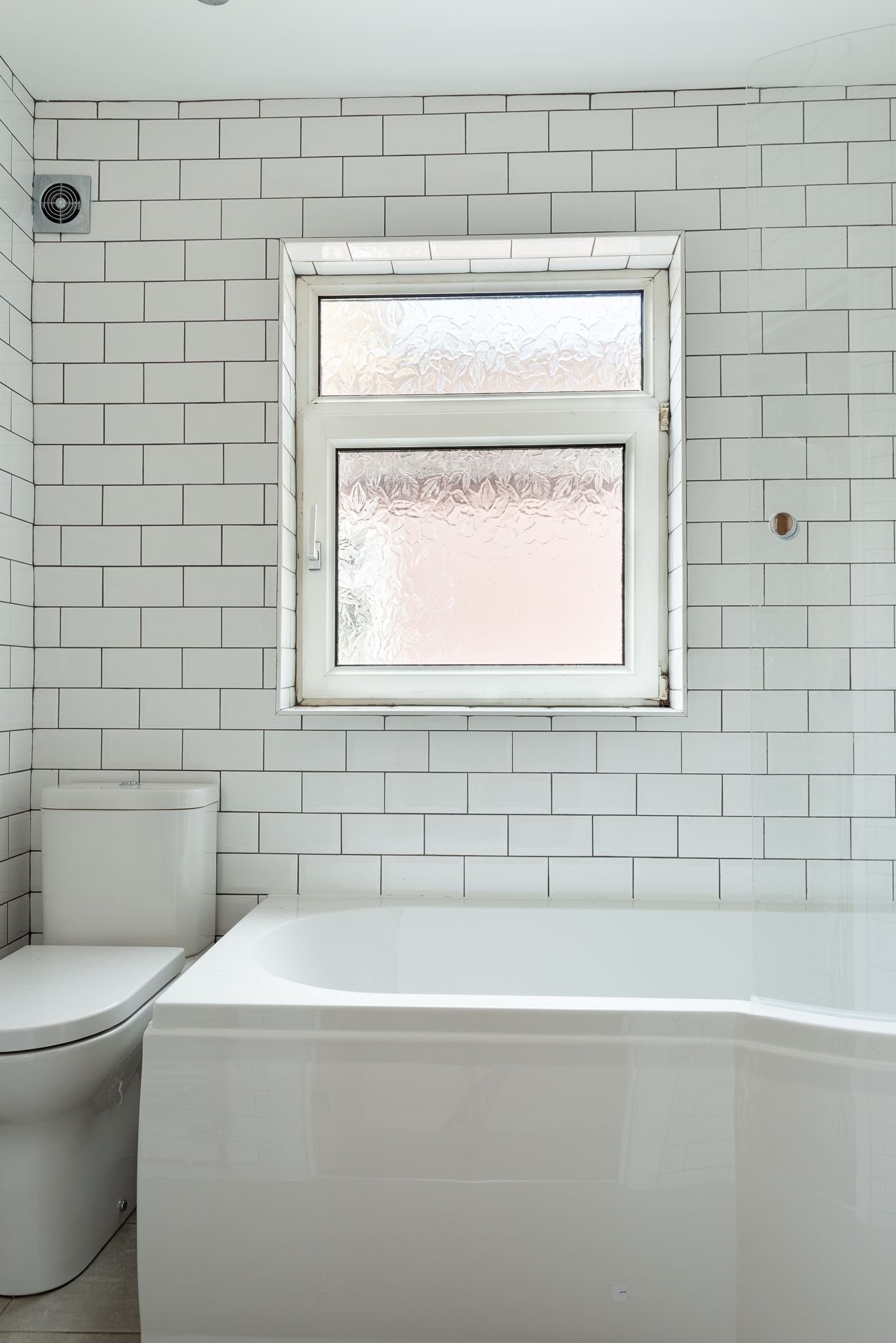 Modern white subway tiles in a fresh bathroom renovation in Walthamstow E17 by Ibex Builders.