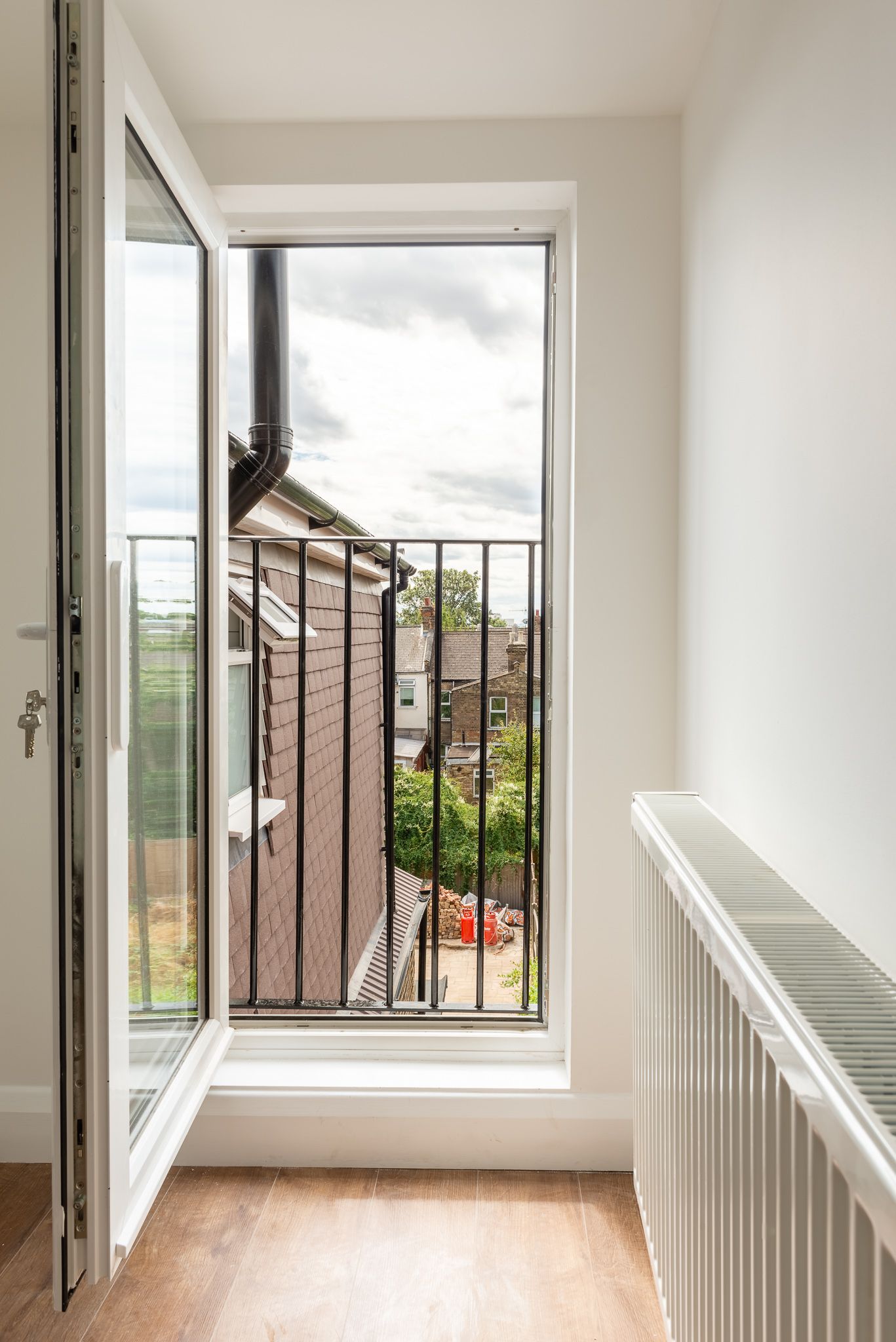Loft conversion with Juliet balcony and panoramic views of Walthamstow E17 by Ibex Builders.