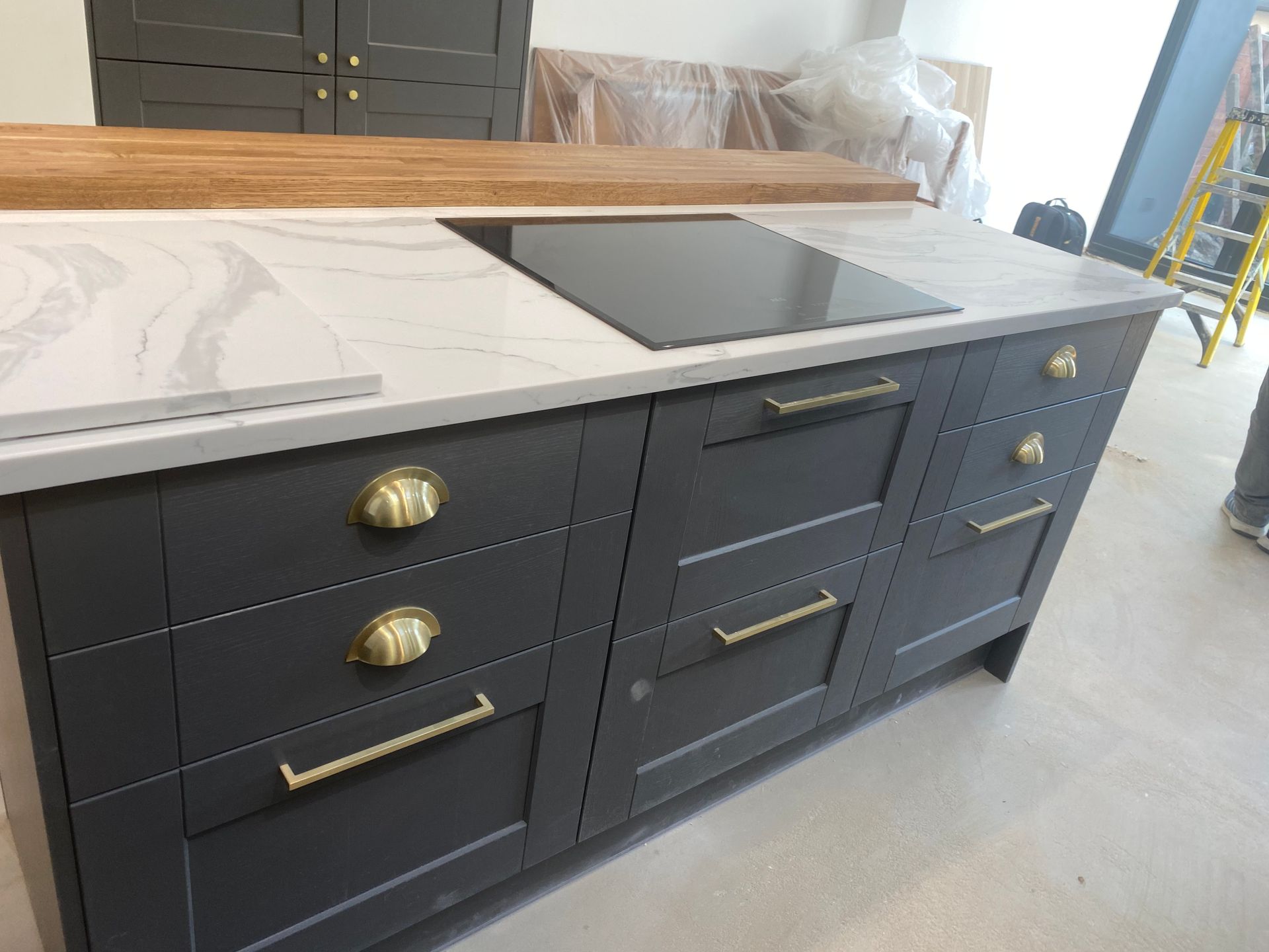 Sleek grey kitchen units island and marble tops in a Leytonstone E11 extension by Ibex Builders.