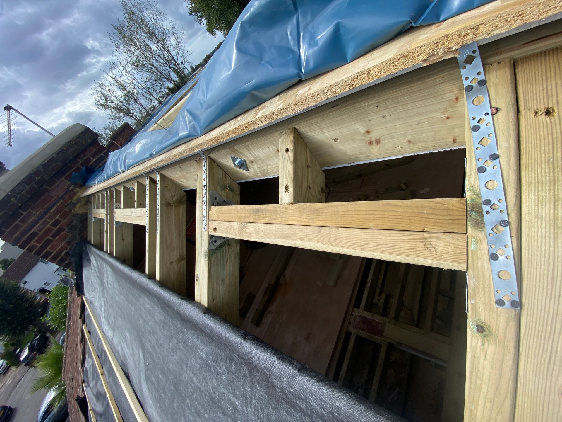 Detailed view of structural timber framing and steel reinforcements for a professional loft conversion.