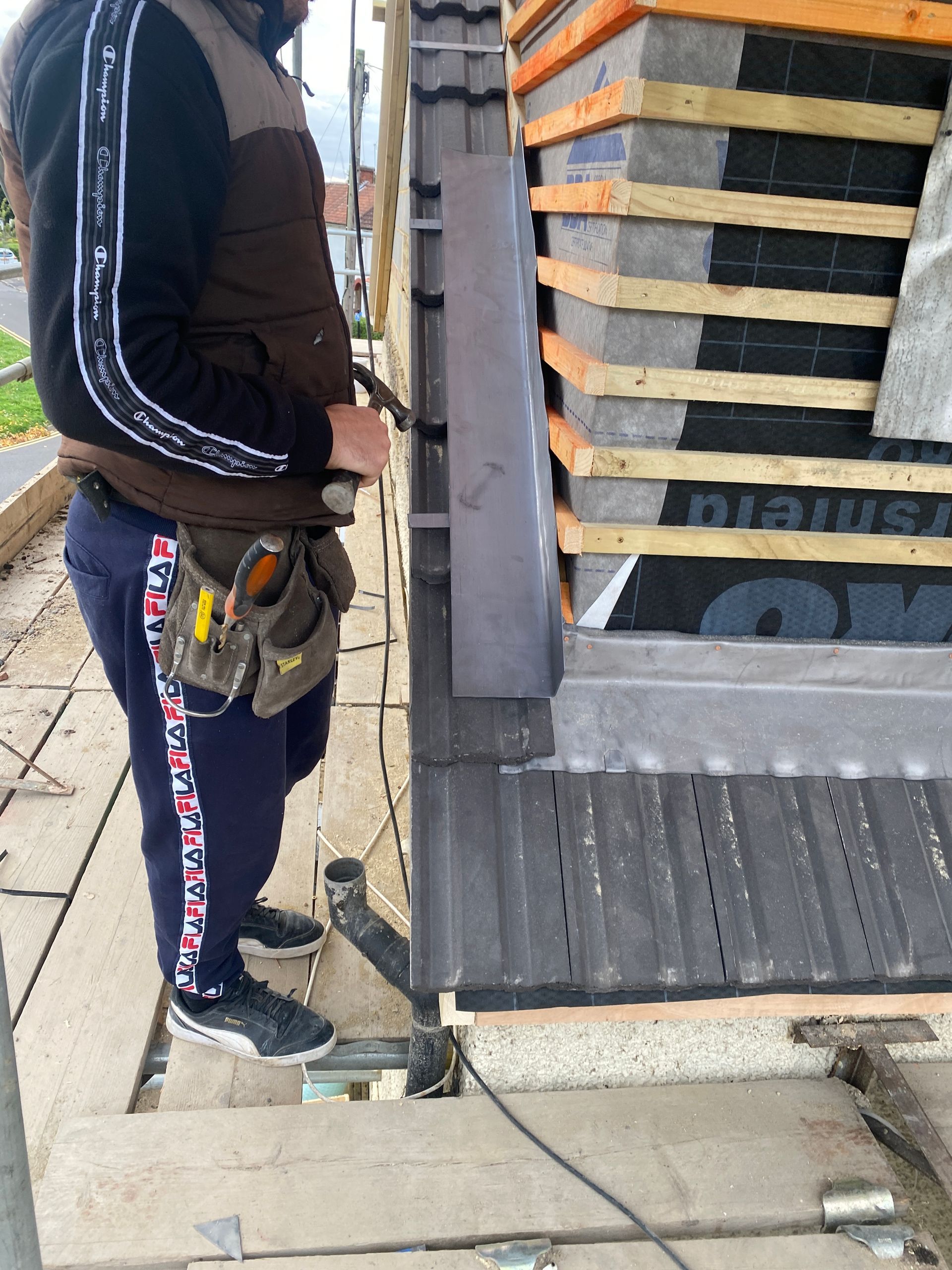 Ibex Builders specialist installing roof tiles on a high-quality loft conversion in Broadfield Sq.