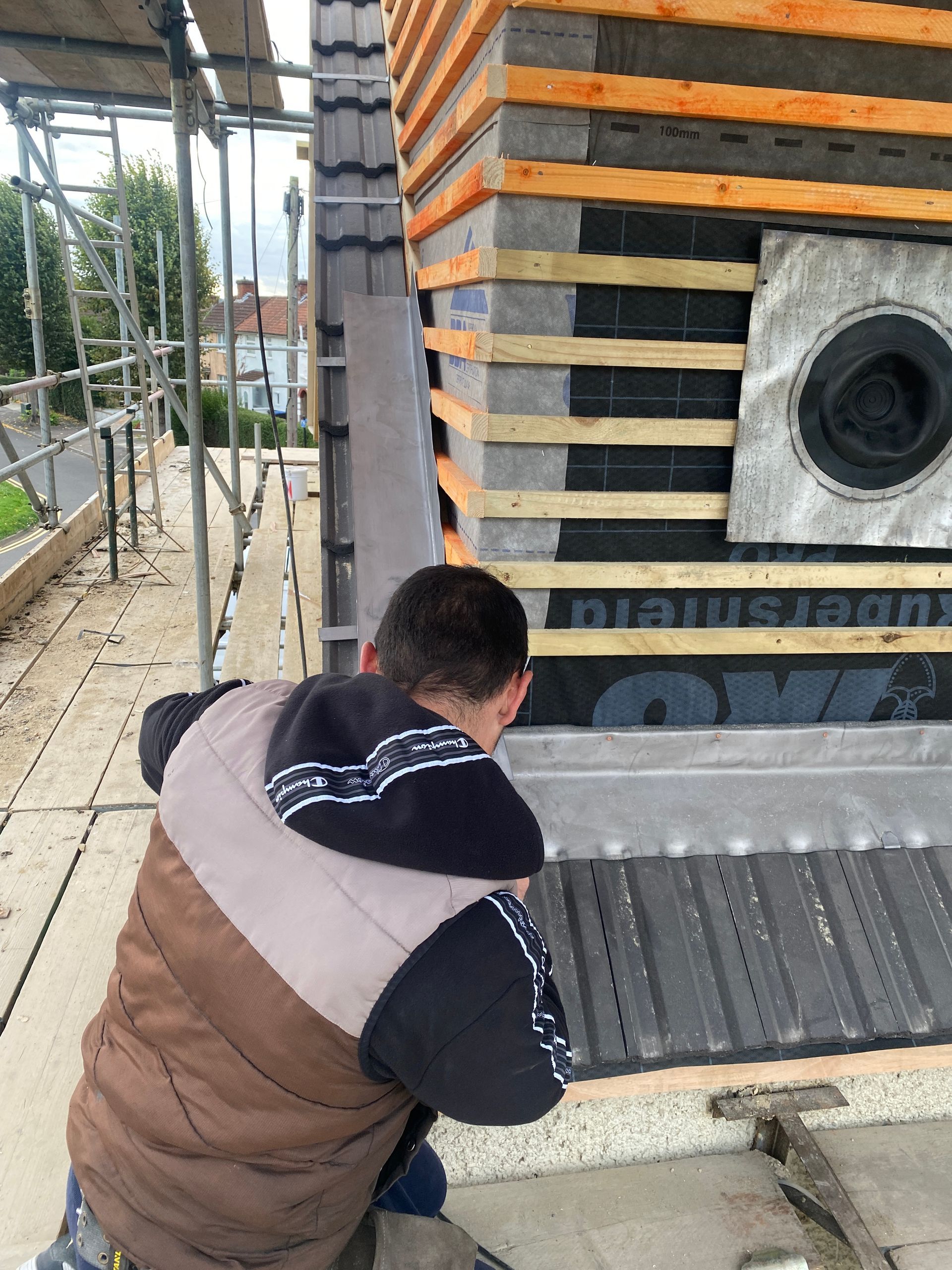 Detail of exterior wall tiling and insulation by Ibex Builders during a professional loft conversion.