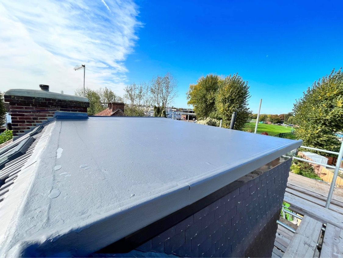 Smooth grey flat roof installation for a modern dormer loft conversion in Broadfield Square.