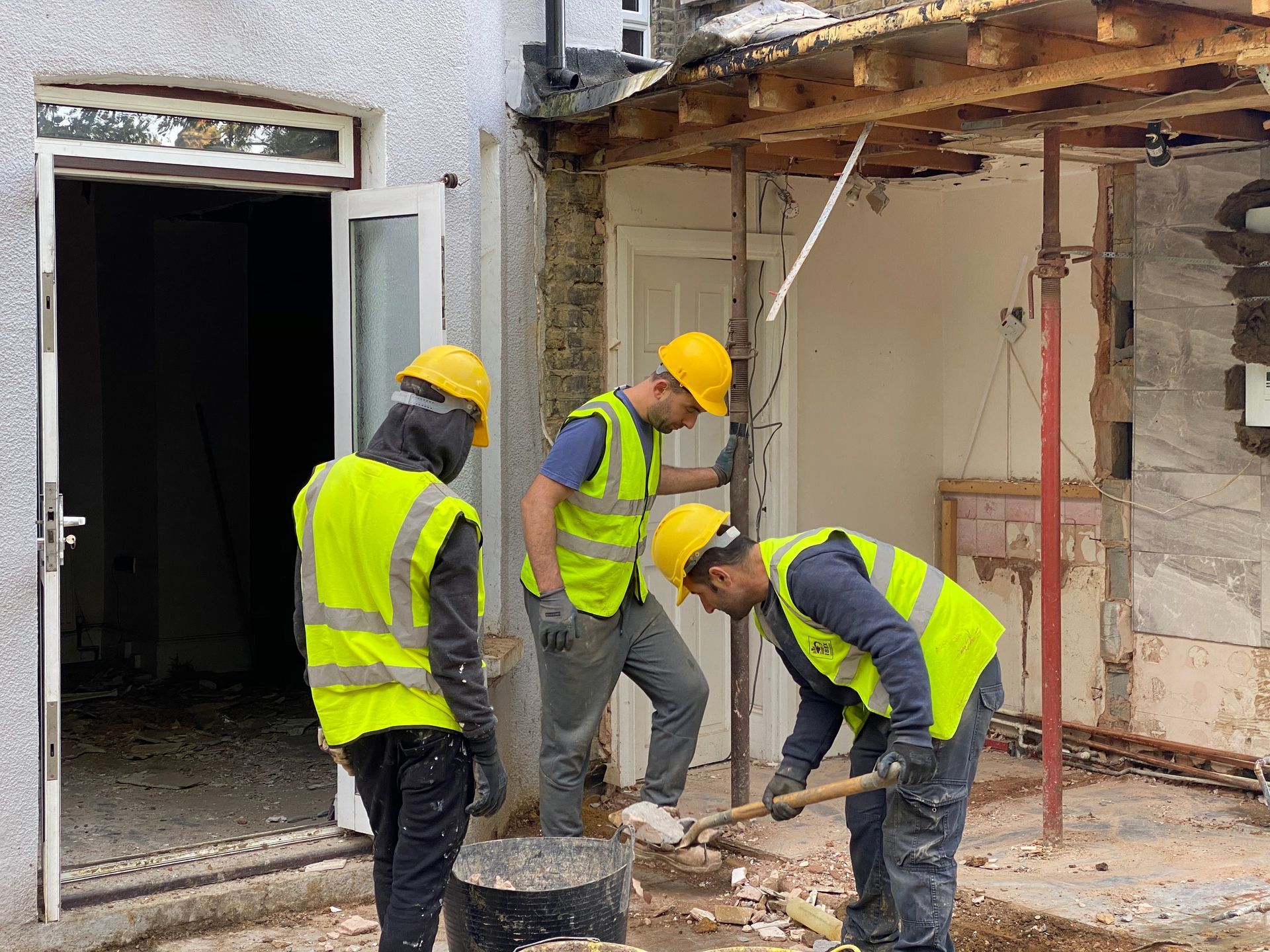 Ibex Builders team preparing the ground for structural footings in a Walthamstow E17 garden site.
