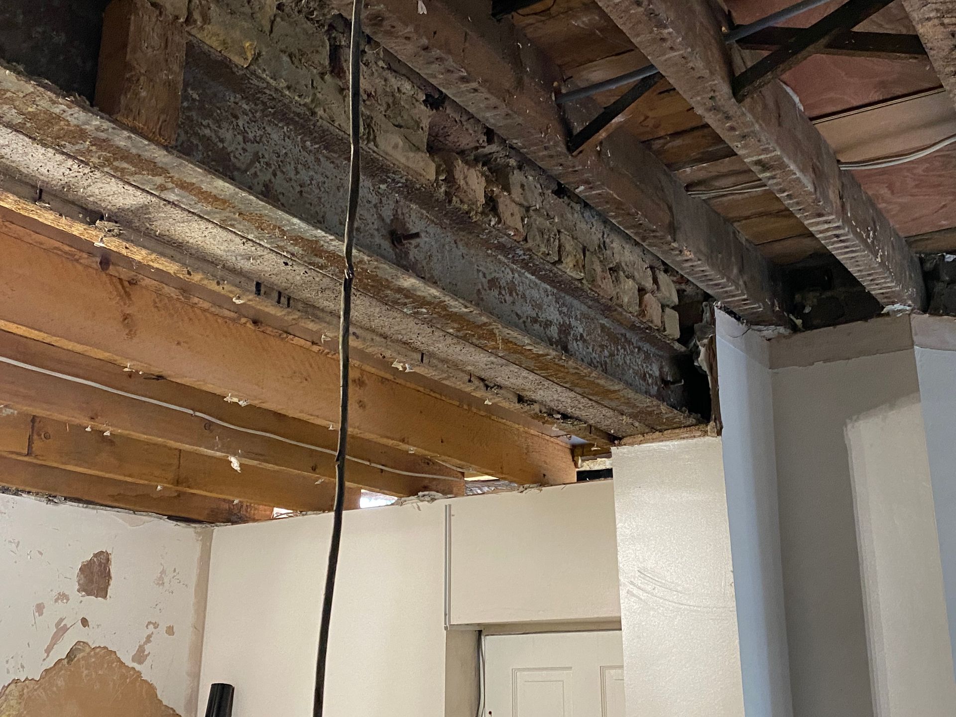 Close-up of original timber joists and new steel beams for an Ibex Builders E17 project.