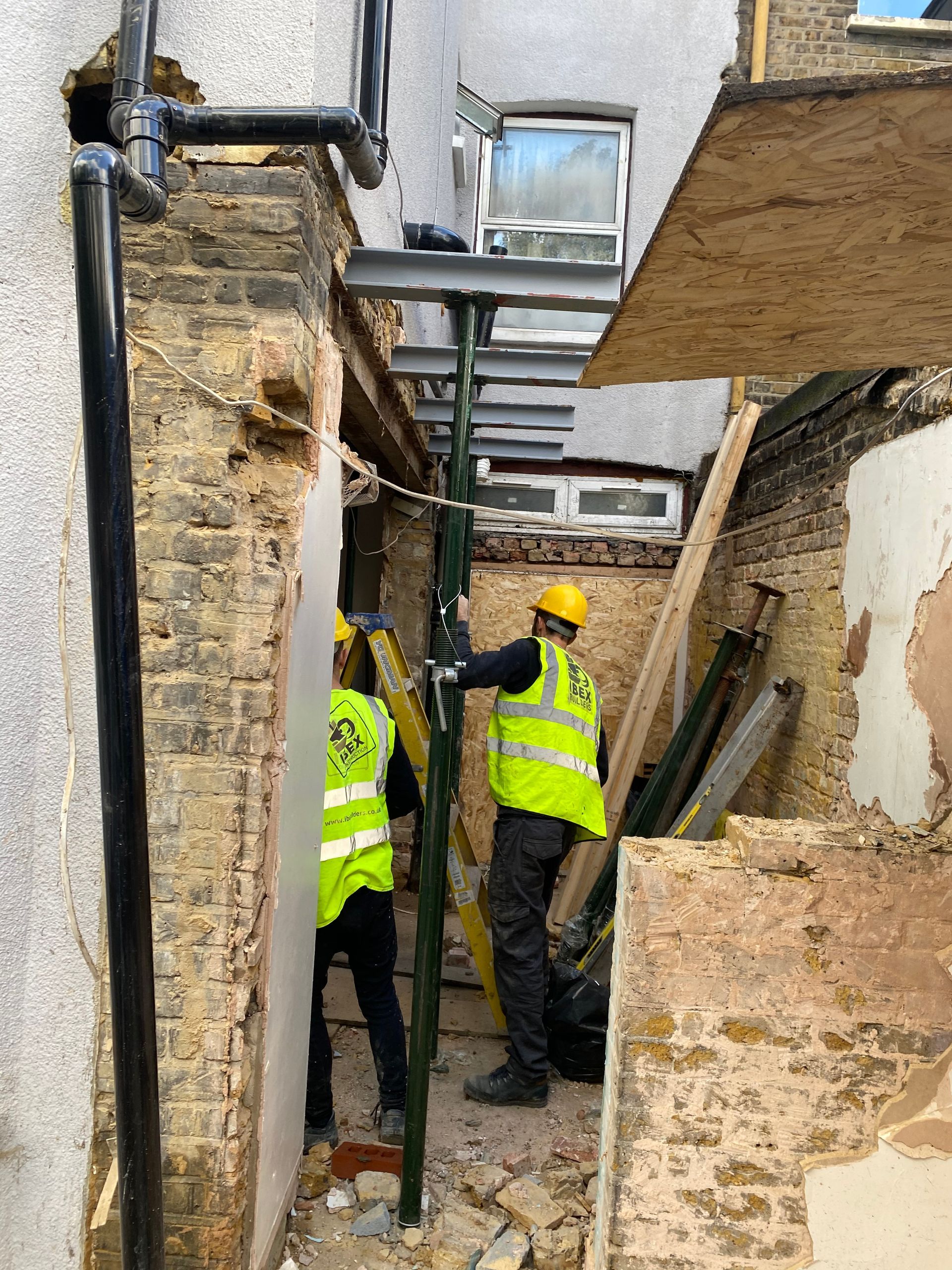 Specialized Ibex Builders team member installing steel supports for a London E17 home renovation.