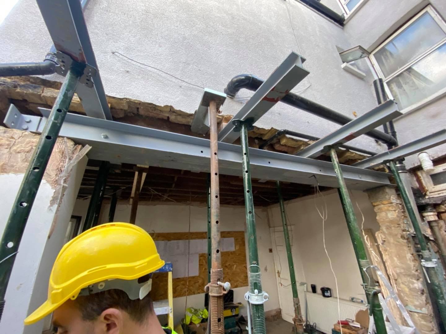 Ibex Builders team securing heavy-duty structural steelwork for a London E17 home extension.