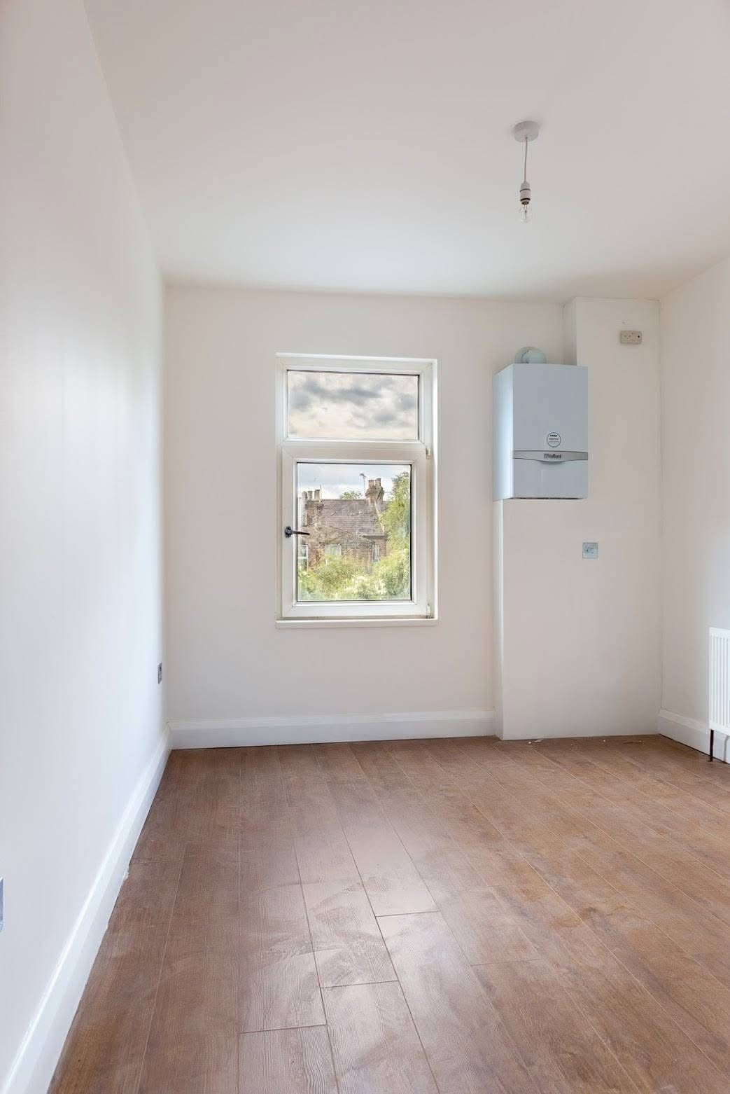 Bedroom renovation with new window and radiator in Walthamstow E17 by Ibex Builders.