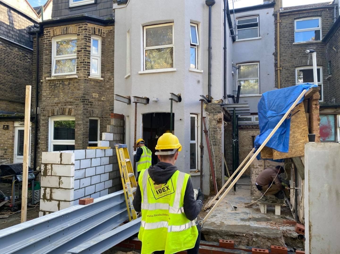 Ibex Builders team members installing heavy-duty steel beams for a kitchen extension in E17.