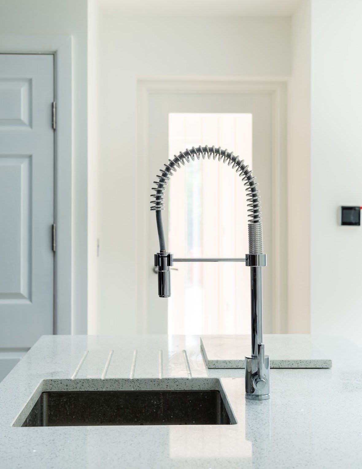 Contemporary professional-style kitchen tap detail in a Walthamstow E17 home renovation by Ibex Builders.