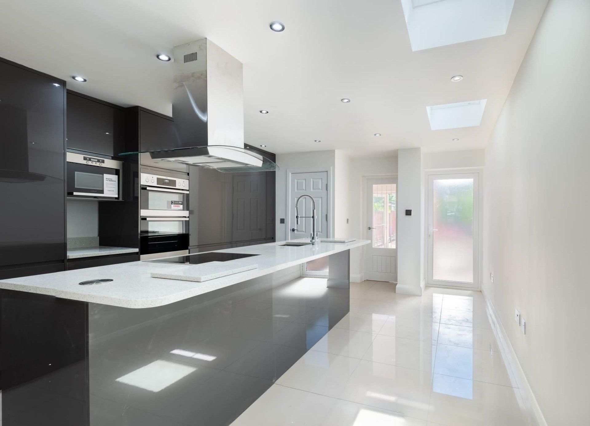 Spacious open-plan kitchen extension  and dining area with garden access in Walthamstow by Ibex Builders.