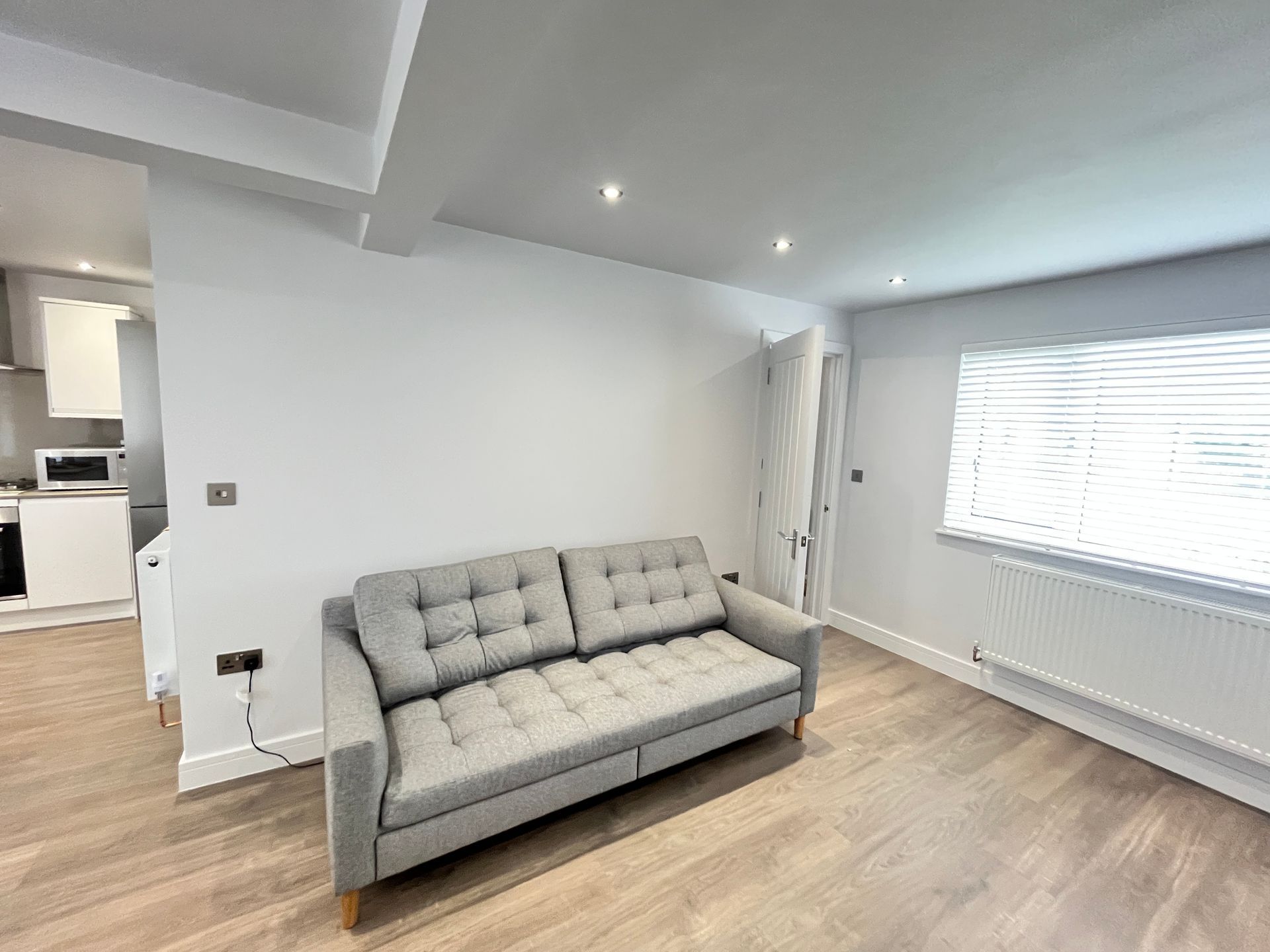 living-area-sofa-gray-wood-flooring-bright-space