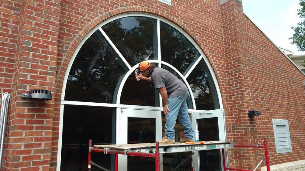 Man Cleaning the Window — Burlington, NC — Alamance Glass Inc.