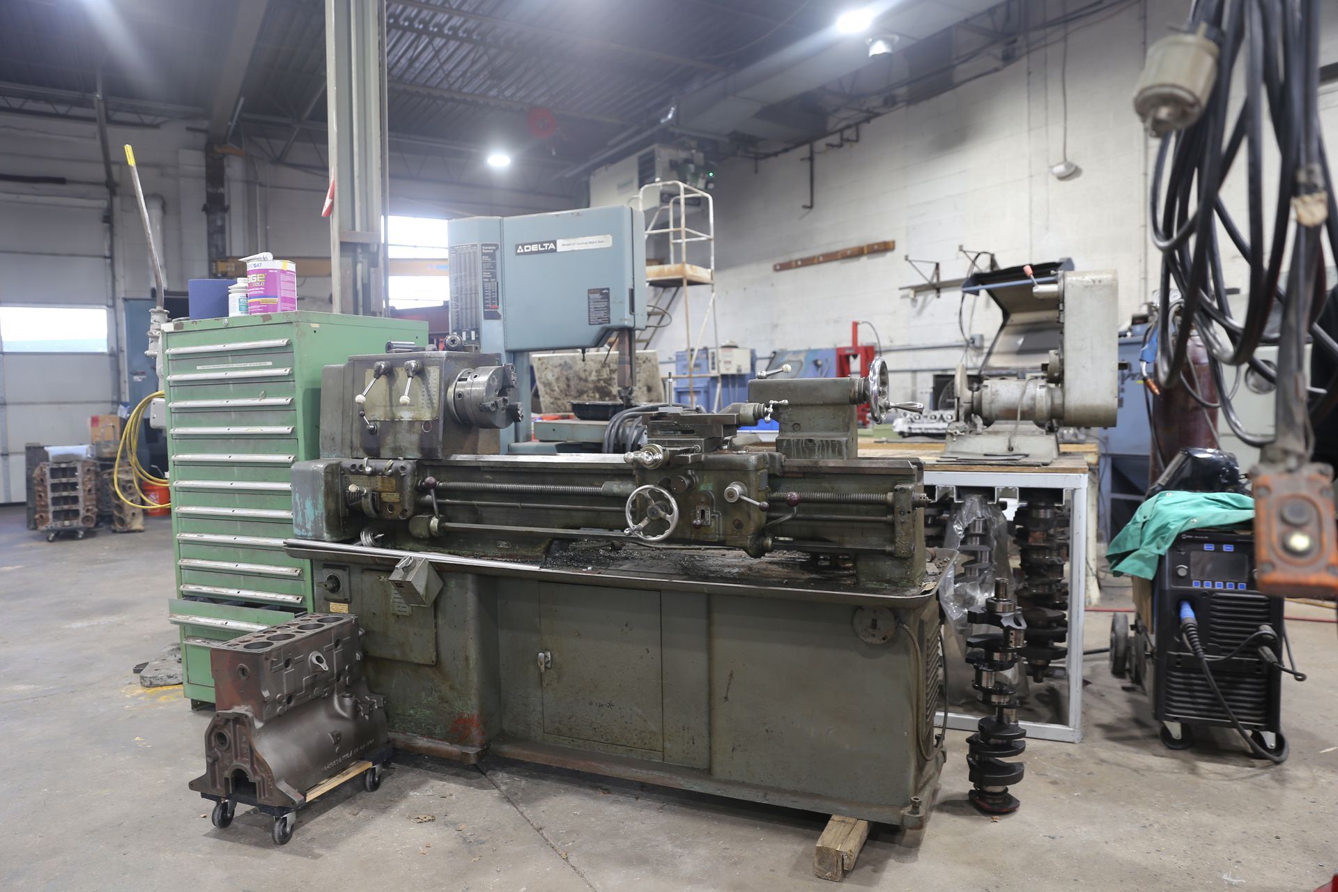 Lathe and other machinery in a workshop, possibly for engine repair.