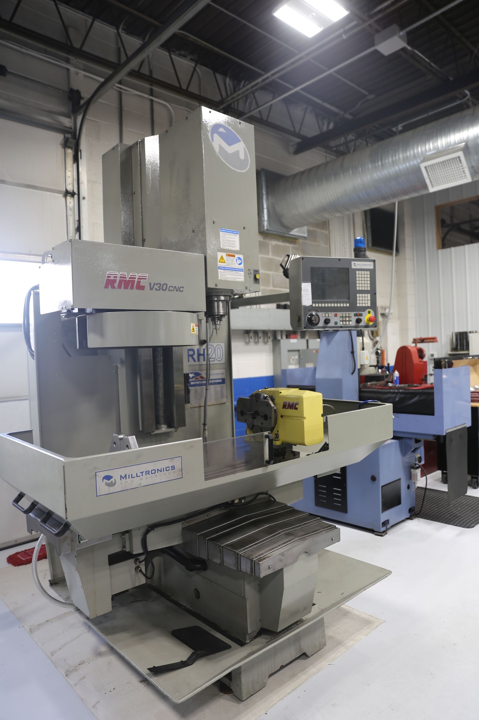 Large gray CNC milling machine in a workshop.