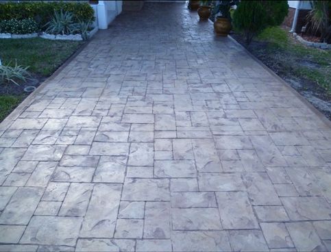 Stamped concrete driveway with a stone pattern.
