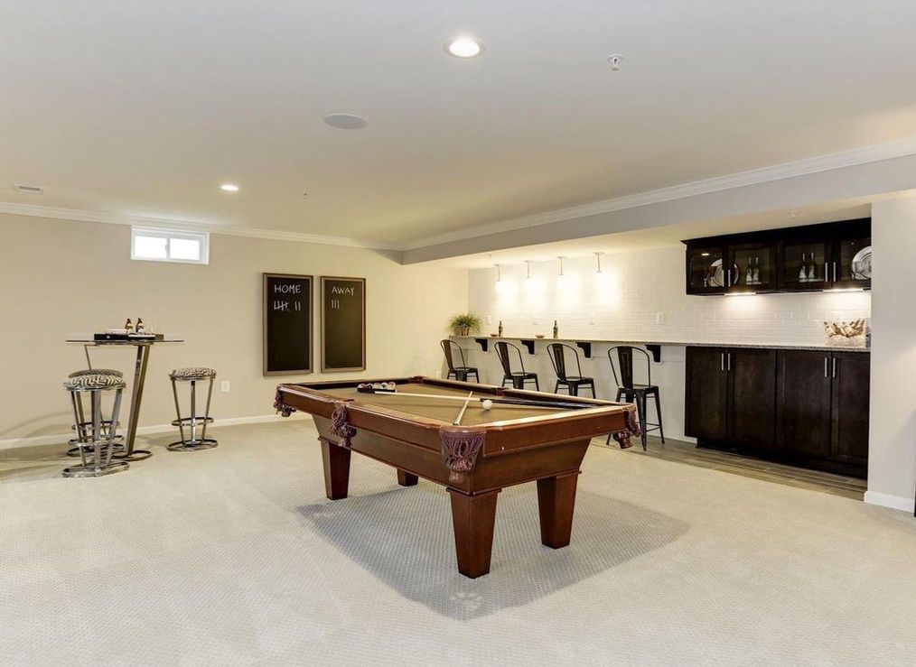 Empty, clean, two-car garage with white doors, gray floor, and overhead opener system.