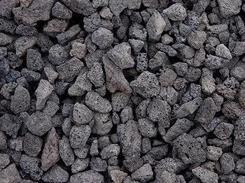 Pile of dark gray, porous lava rocks.