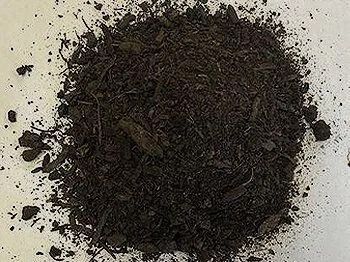 Pile of dark brown mulch.