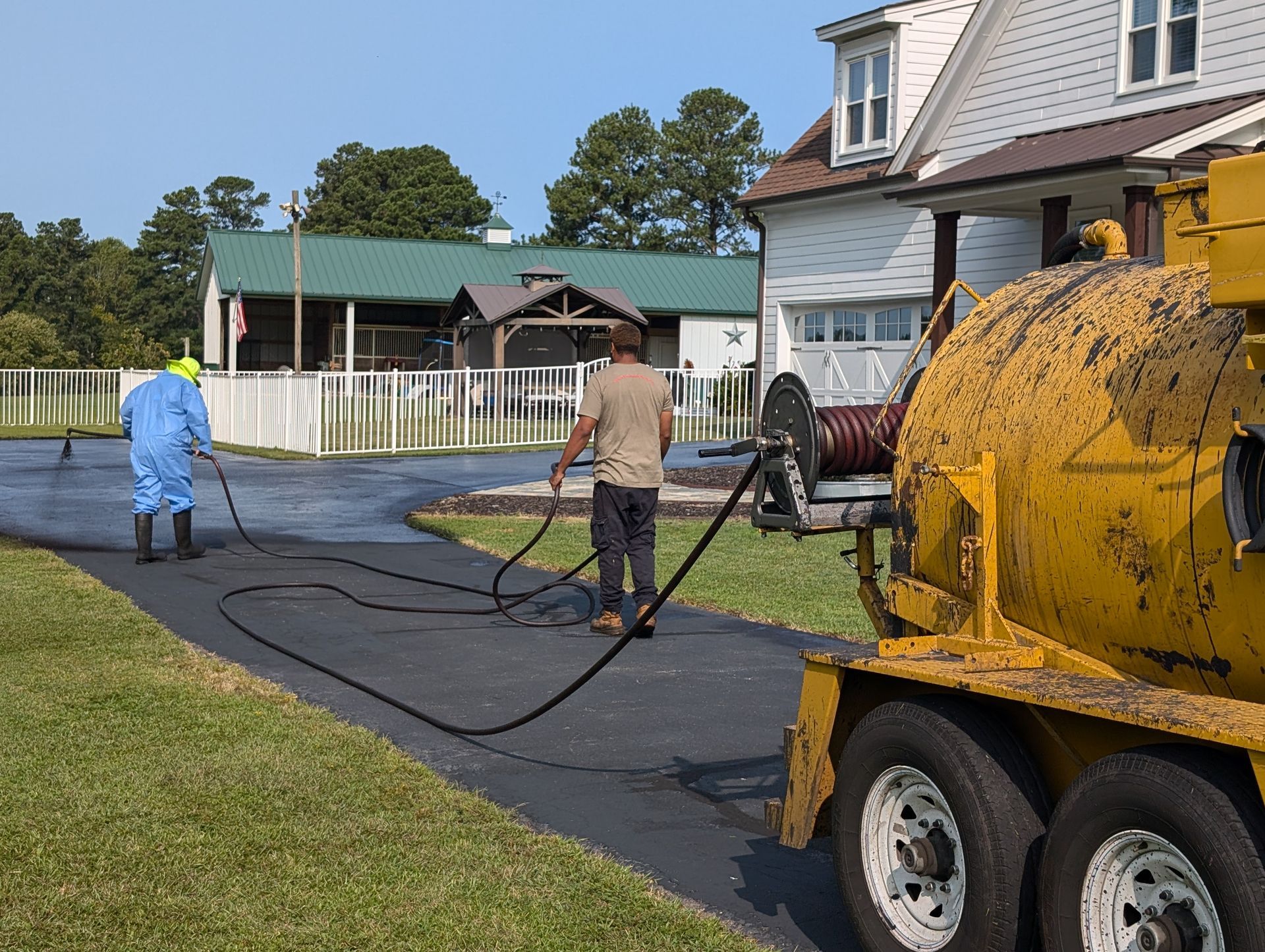 Tier One Asphalt & Sealcoating at work sealcoating an asphalt driveway