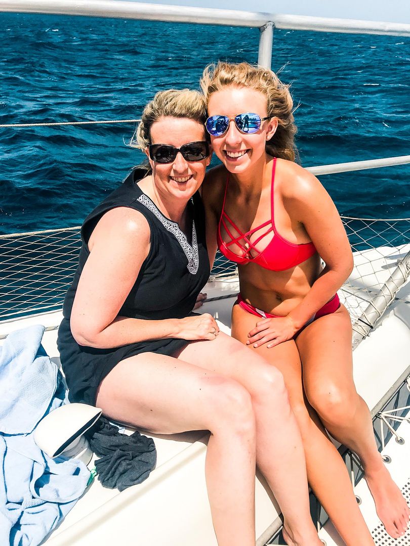 two women sitting on boat smiling