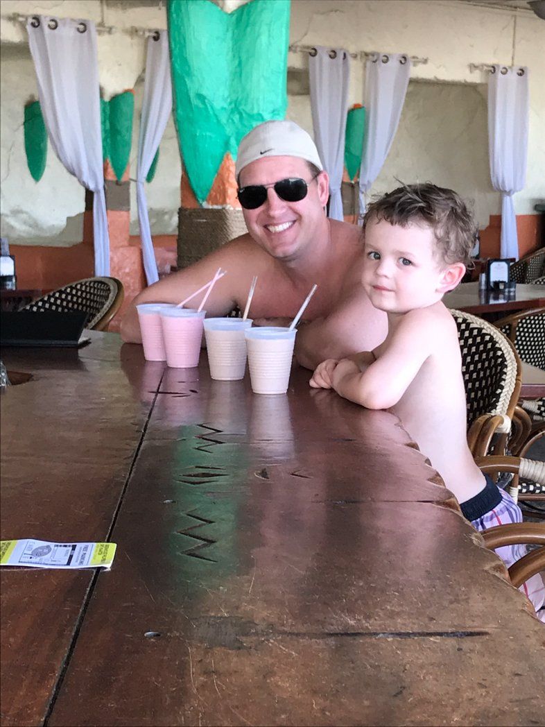 Dad and son sitting at bar in St Maarten